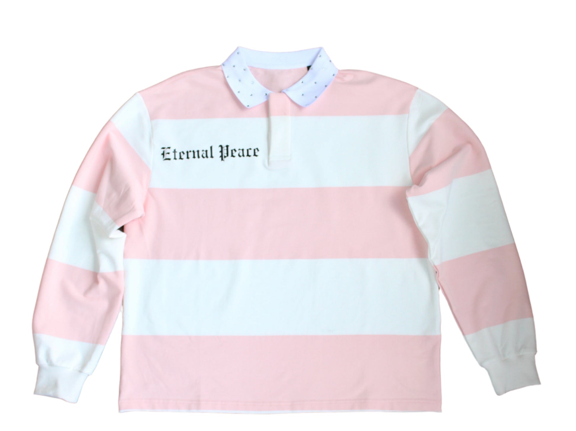 Pink and white striped sweatshirt with 'Eternal Peace' text on a wooden floor.