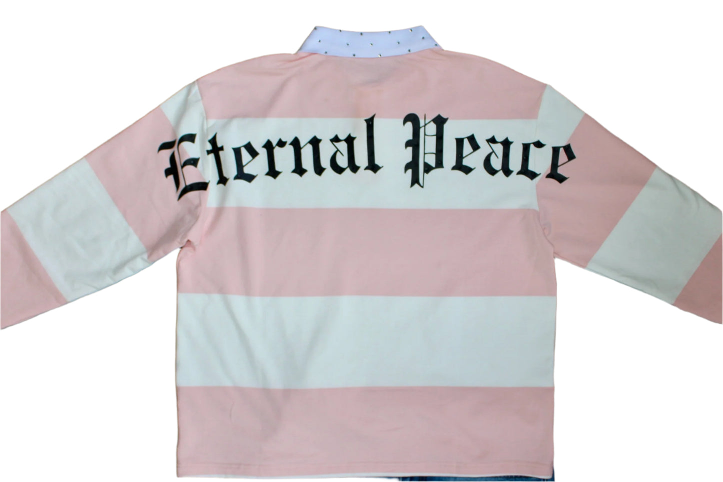 Pink and white striped shirt with 'Eternal Peace' text on a wooden background