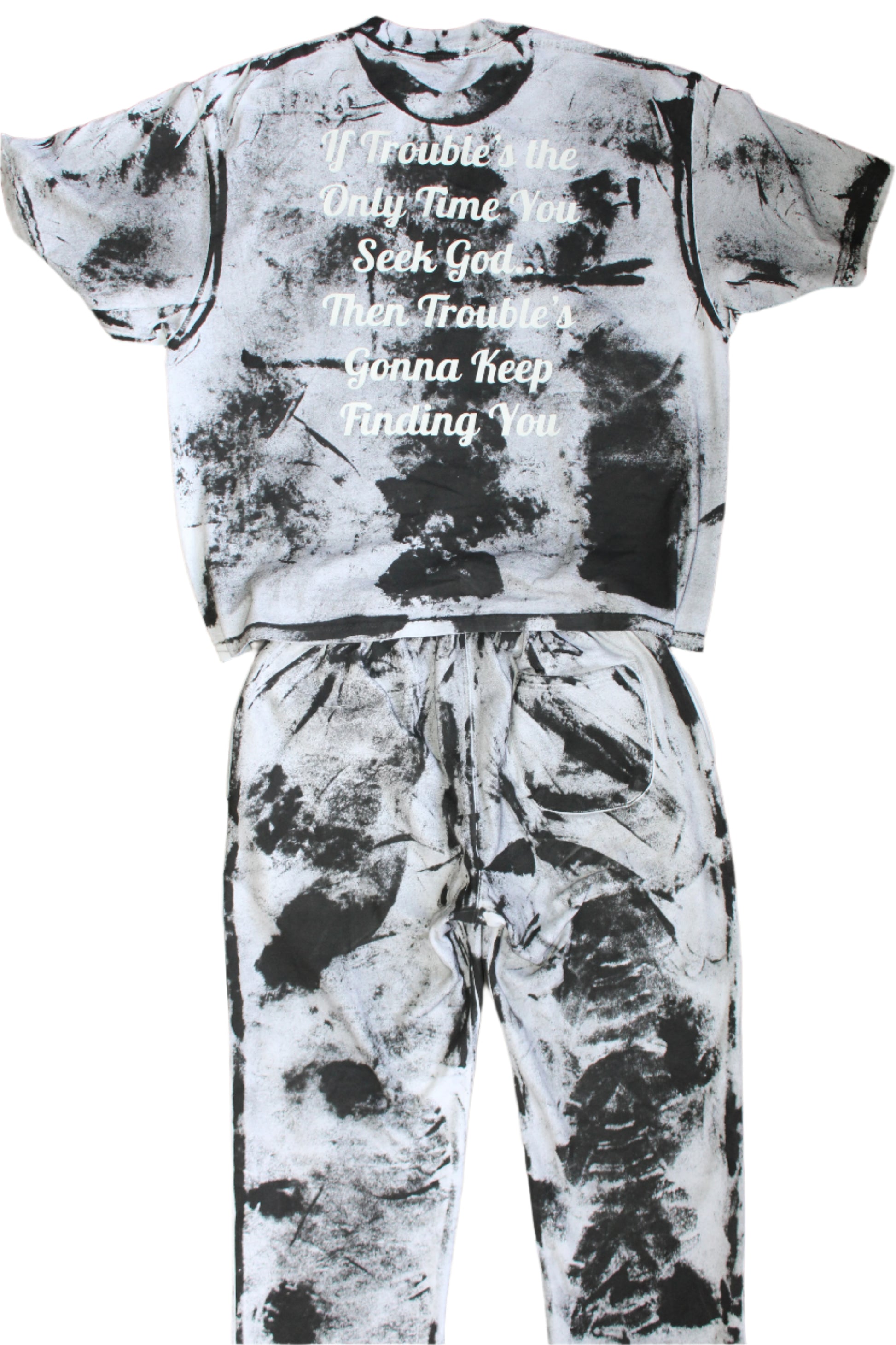 Black and white tie-dye outfit with text on a tiled floor