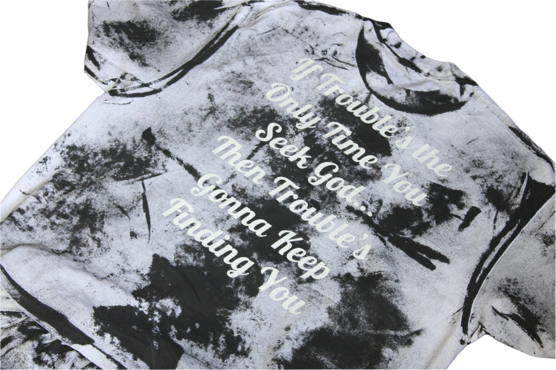 Black and white tie-dye hoodie with text on a wooden surface